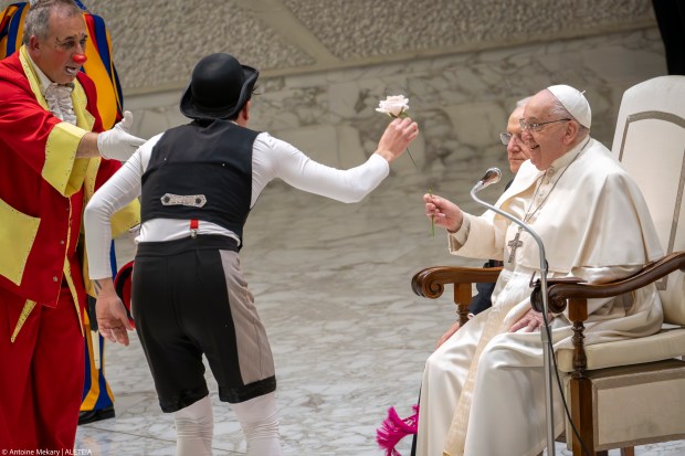 A member of the Rony Roller Circus gives a rose to Pope Francis during the weekly general audience at the Vatican, Wednesday, Jan. 15, 2025.