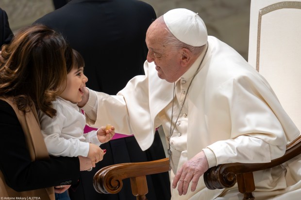 Pope Francis blesses a little girl at the end of his weekly general audience in Paul VI Hall at the Vatican on January 15, 2025.