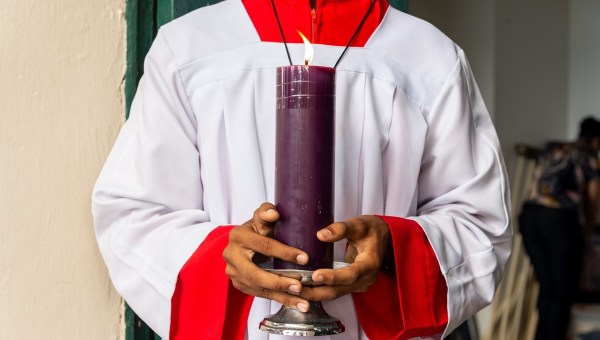 Seminarian carries the torch