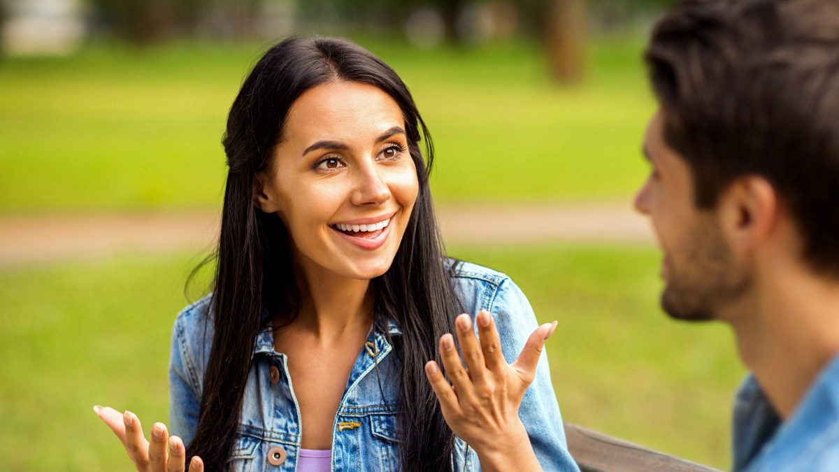woman speaking to man outside