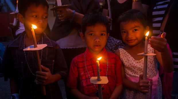 Filipino kids at a candle light vigil