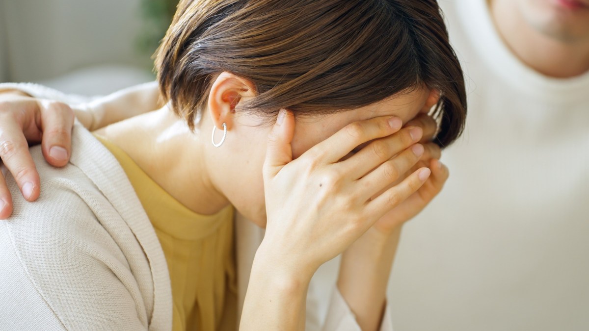Woman who is upset comforted by husband