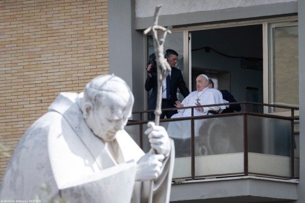 Pope Francis waves from a window of the Gemelli hospital before to be discharge after a five weeks hospitalization for pneumonia, in Rome on March 23, 2025