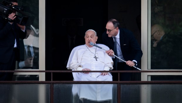 Pope Francis waves from a window of the Gemelli hospital before to be discharge after a five weeks hospitalization for pneumonia, in Rome on March 23, 2025.