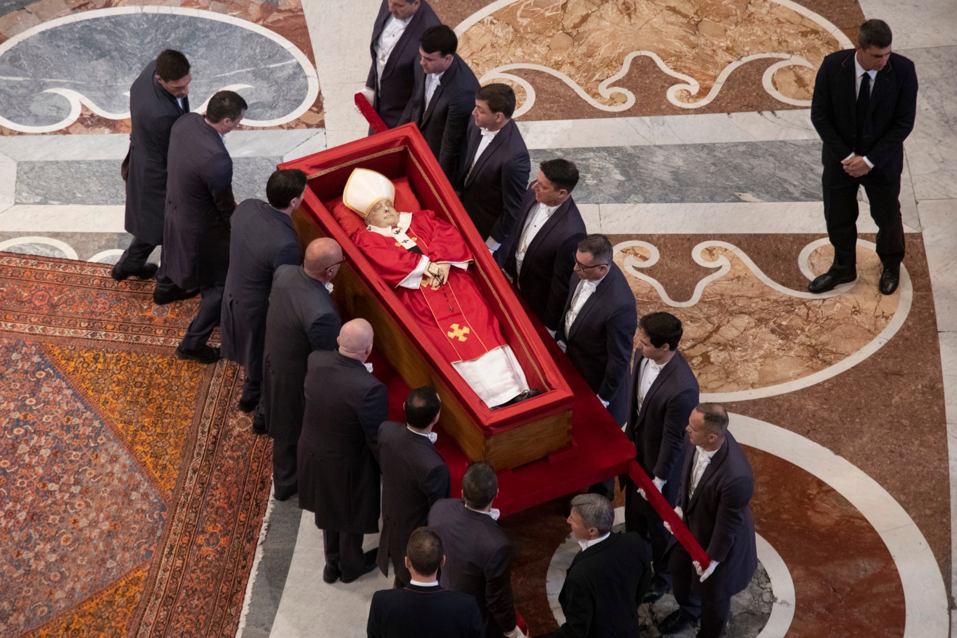 Pallbearers carry the coffin of the late Pope Francis inside St Peter's Basilica as it is transported in a procession from the chapel of Santa Marta to St Peter's Basilica, following the Pope's death, in the Vatican on April 23, 2025.