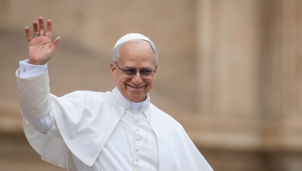 Pope Leo XIV waves to the crowd at the end of his first weekly general audience at St Peter's Square in The Vatican on May 21, 2025.