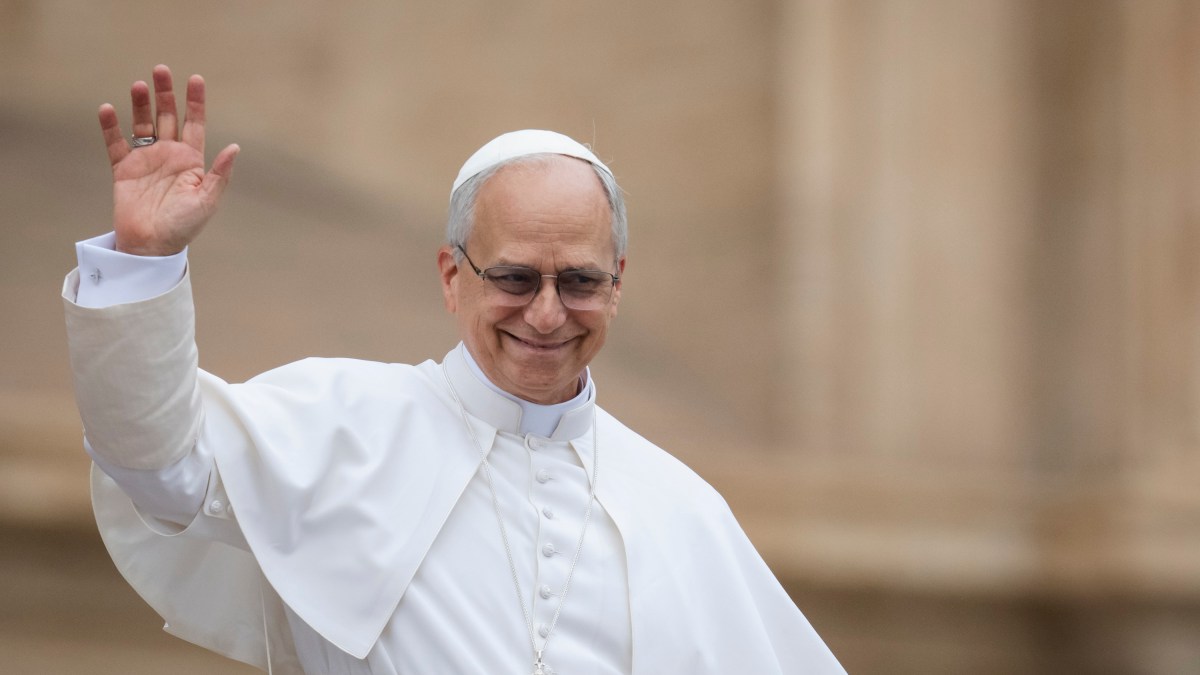 Pope Leo XIV waves to the crowd at the end of his first weekly general audience at St Peter's Square in The Vatican on May 21, 2025.