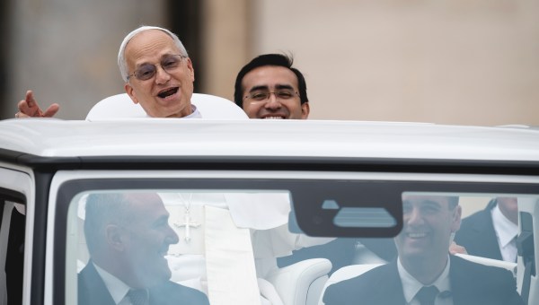 Pope Leo XIV with his personal assistant Edgard Ivan Rimaycuna Inga at the end of his first weekly general audience at St Peter's Square in The Vatican on May 21, 2025.