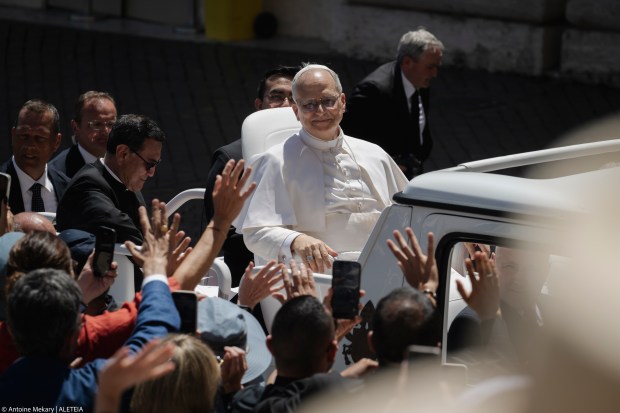 Pope Leo XIV waves to the crowd as he leaves on a popemobile after the weekly general audience at St Peter's Square at The Vatican, on May 28, 2025