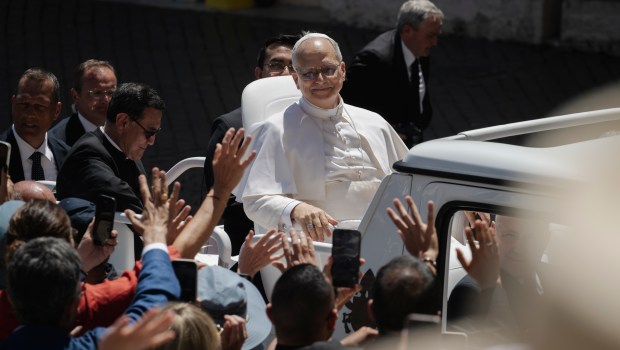 Pope Leo XIV waves to the crowd as he leaves on a popemobile after the weekly general audience at St Peter's Square at The Vatican, on May 28, 2025