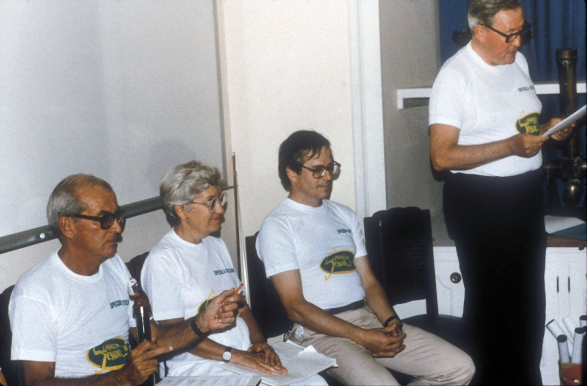 People sitting in white shirts.