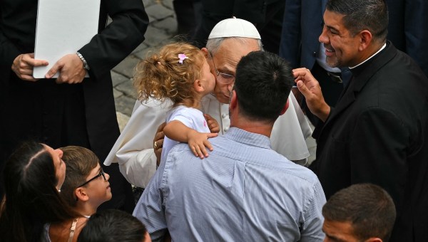 child kisses Pope Leo