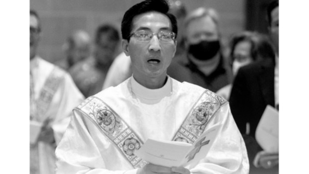 Priest holding paper