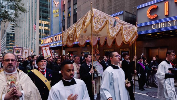 Priests bringing Eucharist by Radio City Music Hall