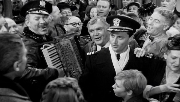 Ward Bond on accordion, Charles Halton (in round glasses), Thomas Mitchell, Todd Karns (in uniform), Frank Faylen, and Beulah Bondi.