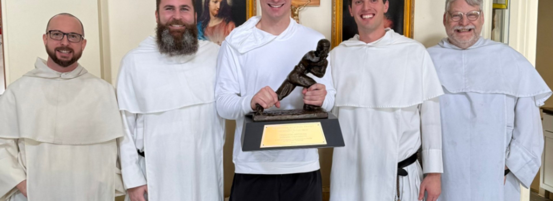 Heisman winner Fernando Mendoza surrounded by priests
