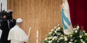 Pope lights candle for the sick before Our Lady of Lourdes