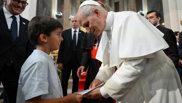 Pope Leo XIV greeting a kid during a meeting with Diocesan charity and welfare organizations in the Church of Sant Augusti in Montserrat