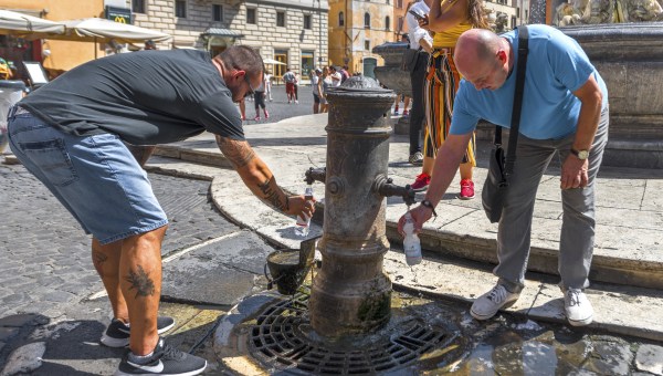Rome, Italy - August 2017: thirsty tourists at city streets in summer heat